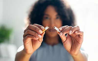 Closeup of patient breaking cigarette