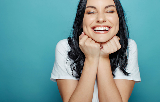 a woman smiling with dental crowns in Garland