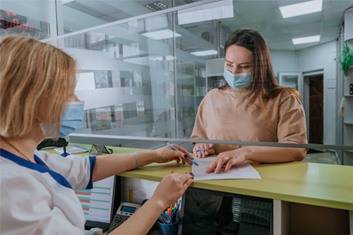 Patient in Garland filling out financing forms for dentures