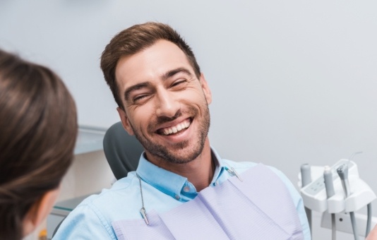 Man smiling at dentist during dental appointment