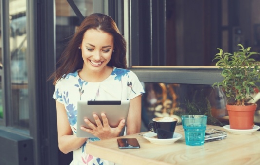 Woman looking at dental insurance forms on tablet computer