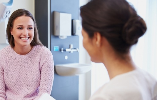 Woman discussing emergency dentistry options with her dentist