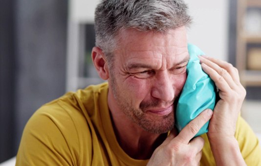 a man with an ice pack on his face