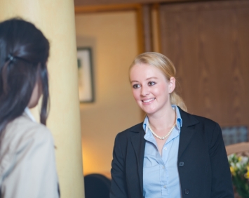 Dental team member greeting dental patient