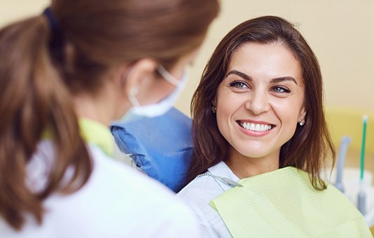  A woman smiling at the dentist