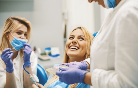 Woman laughing during preventive dentistry checkup and teeth cleaning visit