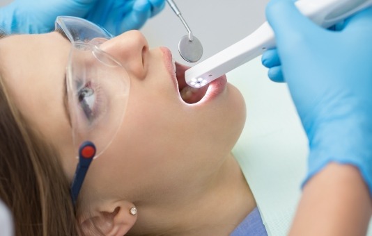 Dentist using intraoral camera to capture smile images