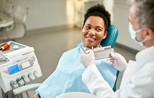 Woman smiling at Garland dentist during veneers consultation