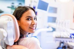 Smiling woman sitting in dental treatment chair