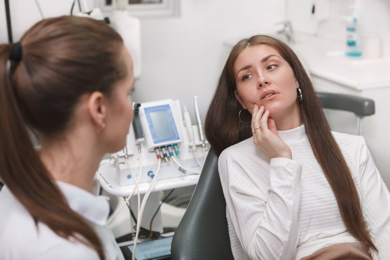 a woman with a dental emergency