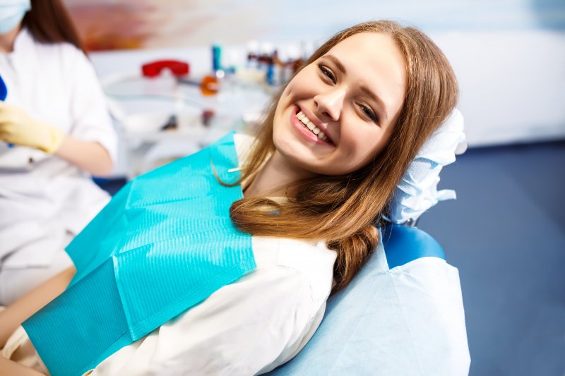 smiling patient in a dental chair