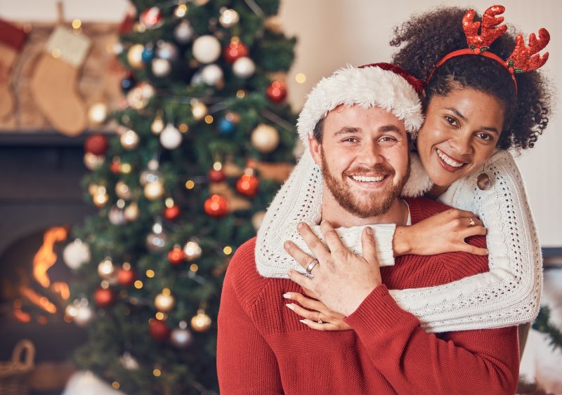 A happy, smiling couple in a holiday setting