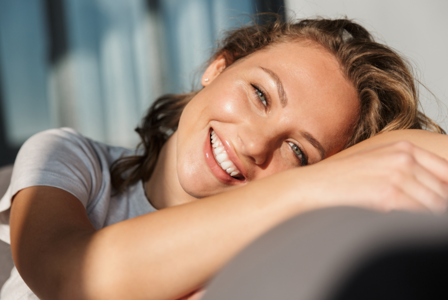 Woman smiling, reclining on chair